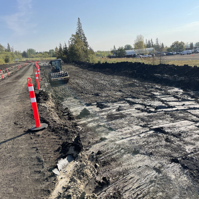 Trench shoring system with an auger boring machine and worker inside the pit