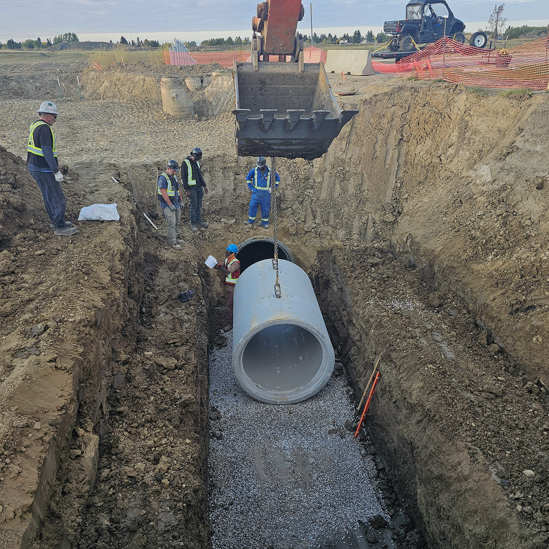 Trench shoring system with an auger boring machine and worker inside the pit