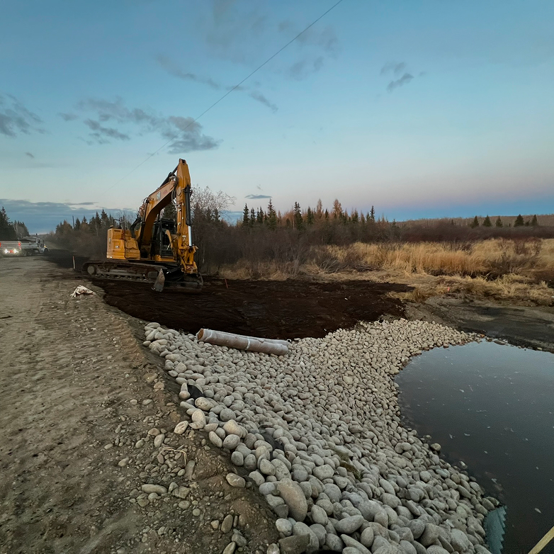 Trench shoring system with an auger boring machine and worker inside the pit
